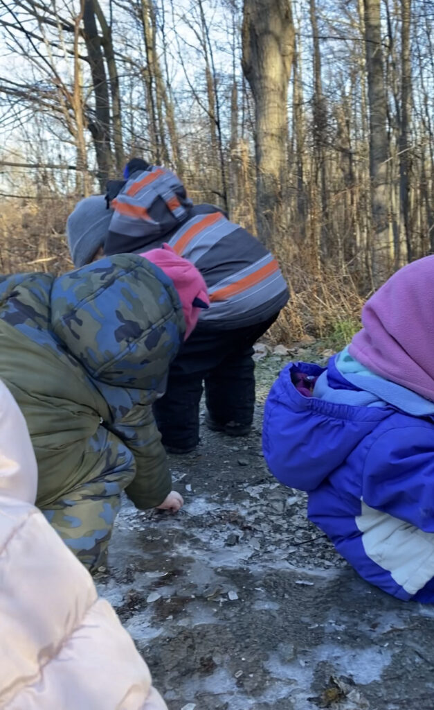 Children exploring icey puddles