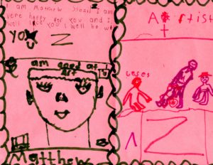 Drawings and writing on pink paper.