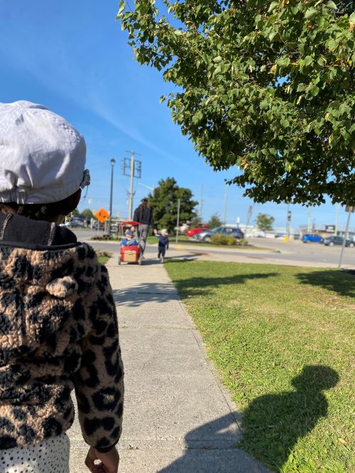 child walking on sidewalk