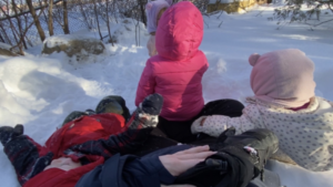 group of toddlers sitting on the snow